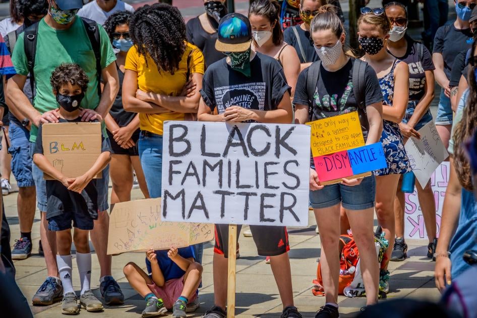 Protesters hold signs at a demonstration in Brooklyn