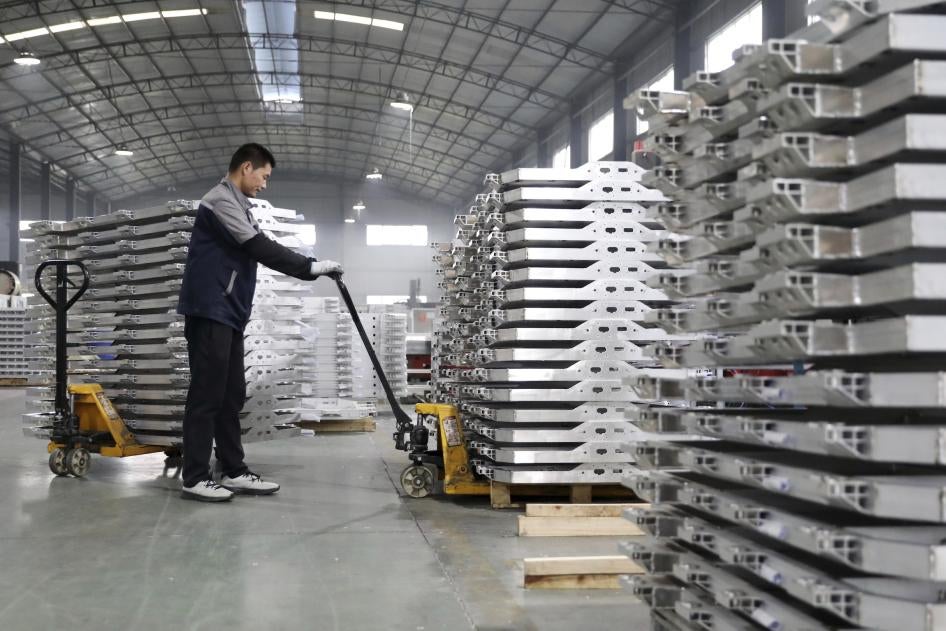 A worker moves aluminum auto parts in central China's Anhui province.
