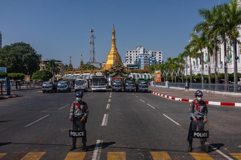 Police block a road leading to City Hall as protesters approach on February 13, 2021, in Yangon, Myanmar. 