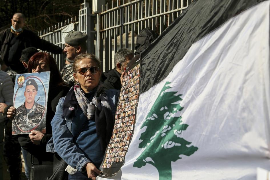 Lebanese activists and families of the victims of the 2020 Beirut port blast gather outside the Palace of Justice to protest a decision by Lebanon's top prosecutor to release the suspects detained in connection with the explosion. 