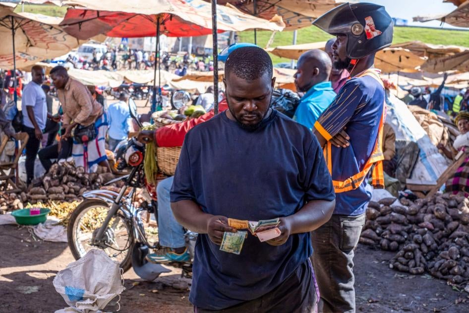 A trader counts out Ghanaian cedi banknotes