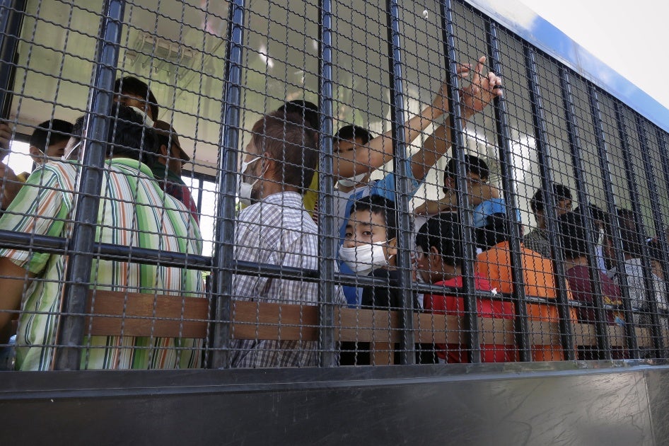 Suspected Uyghurs are transported back to a detention facility in the town of Songkhla in southern Thailand, March 26, 2014.