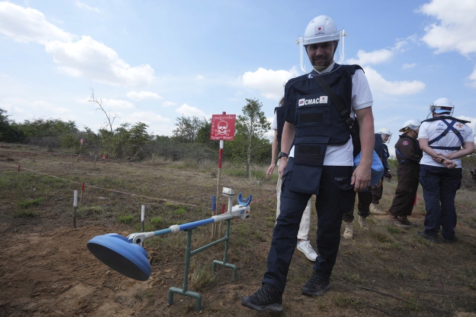 Demining equipment shown next to a deminer in training. 