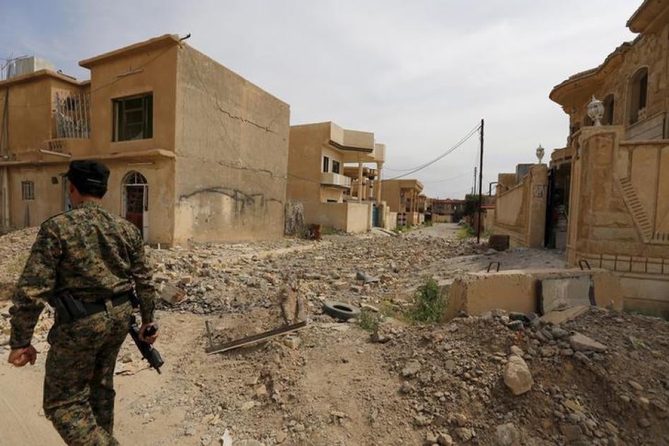 Pro-government fighter walking in a rubble-strewn street in Tikrit, Iraq on April 1, 2015, after the city had been recaptured from ISIS.