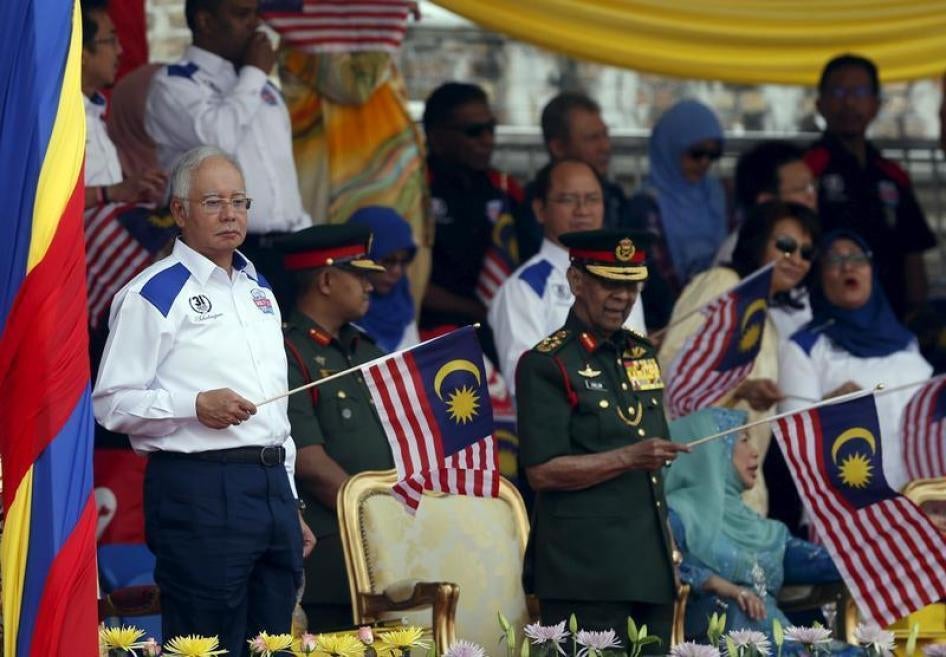 Malaysia's (L-R) Prime Minister Najib Razak and King Abdul Halim Mu'adzam Shah wave Malaysian national flags during National Day celebrations in Kuala Lumpur, August 31, 2015.