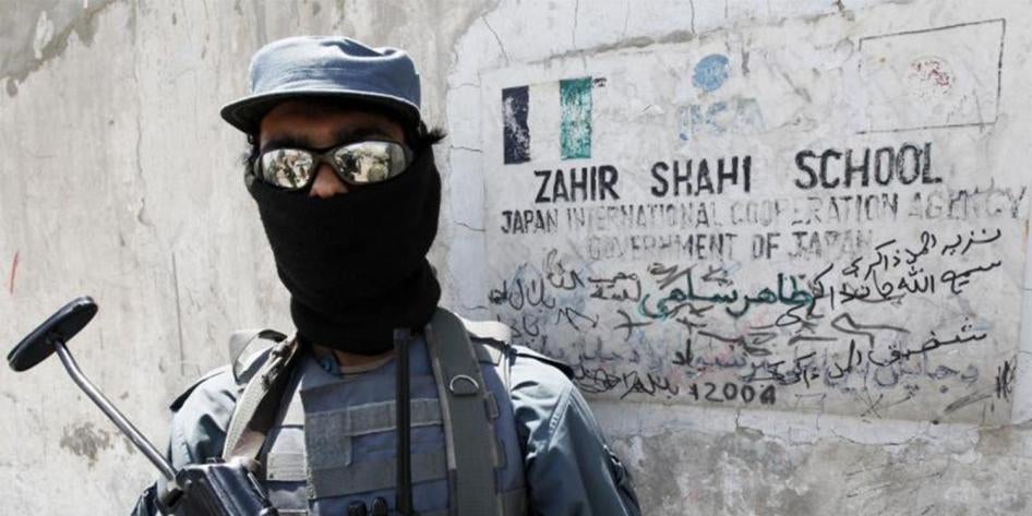 An Afghan policeman stands guard at the entrance of a local school sponsored by Japan’s International Cooperation Agency in Kandahar City May 11, 2010. © 2010 Nikola Solic / Reuters