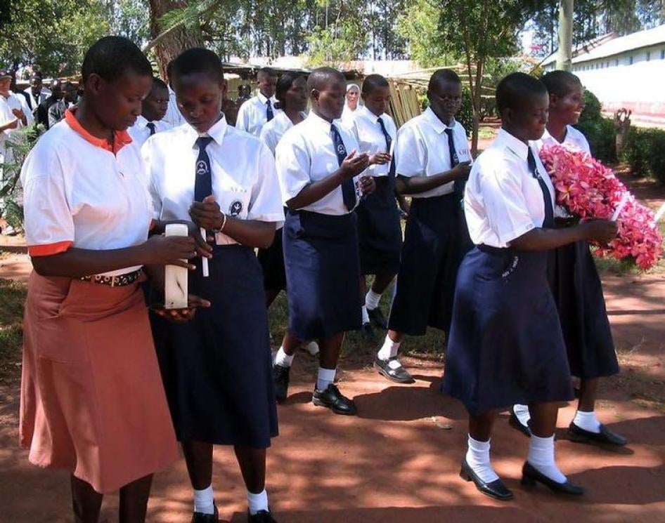 Former abducted Ugandan girls from St. Mary's College in Aboke who returned from captivity by Lord's Resistance Army (LRA) rebels walk with lit candles during a ceremony October 10, 2005 to commemorate the abduction day.