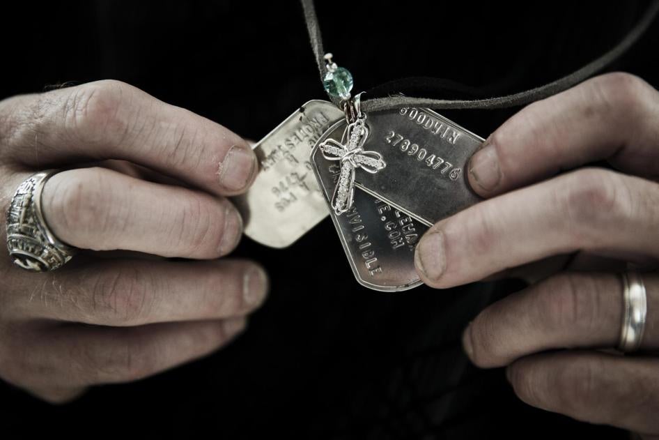 Gary Noling holding dogtags belonging to his daughter, Carri Goodwin, a rape victim who died of acute alcohol intoxication less than a week after receiving an Other Than Honorable discharge from the Marines.