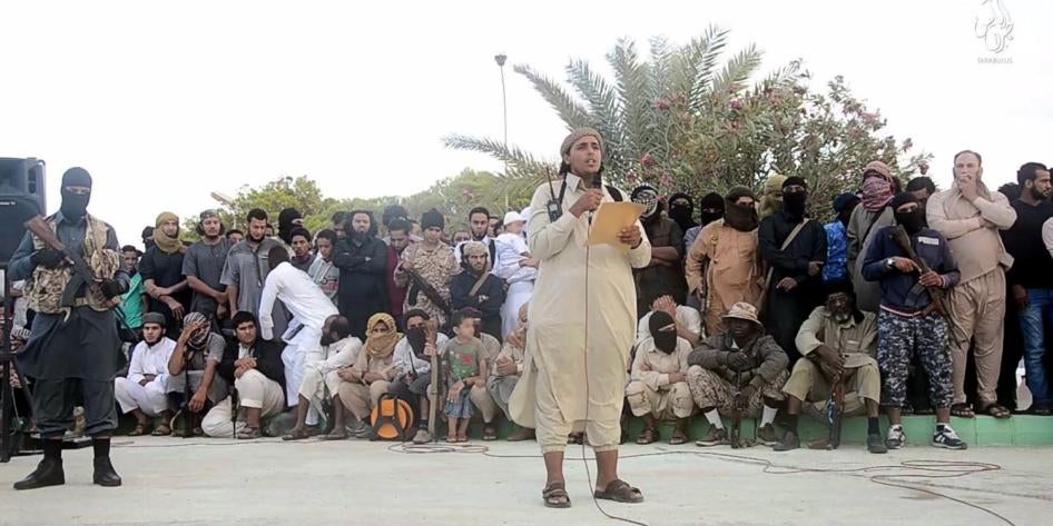 An ISIS official makes an announcement ahead of the execution of two men for “sorcery” in Sirte, Libya. Image from a 2015 Islamic State (ISIS) video. The online clearinghouse Jihadology.net posted the video on its website.