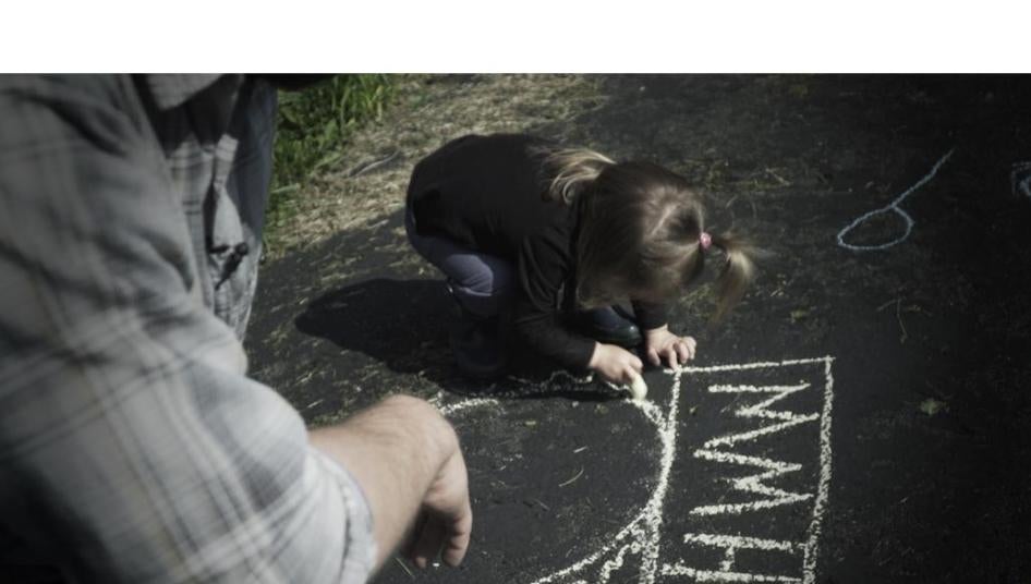 A father plays with his daughter, who was born with atypical sex characteristics. Despite pressure from doctors, the parents chose not to elect medically unnecessary surgeries on their child. 