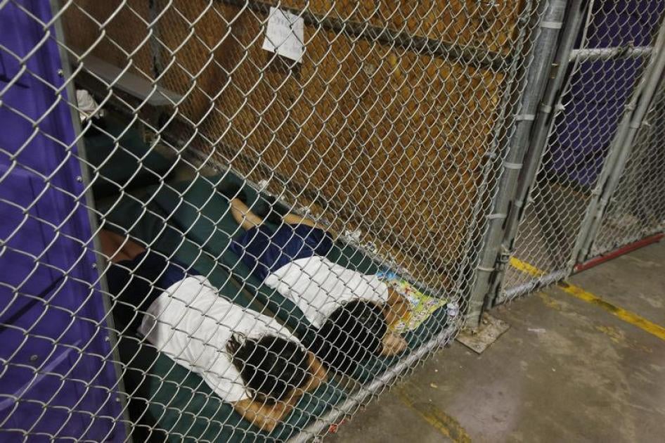 Two female detainees sleep in a holding cell at the U.S. Customs and Border Protection (CBP) Nogales Placement Center in Nogales, Arizona, in this June 18, 2014 file photo.