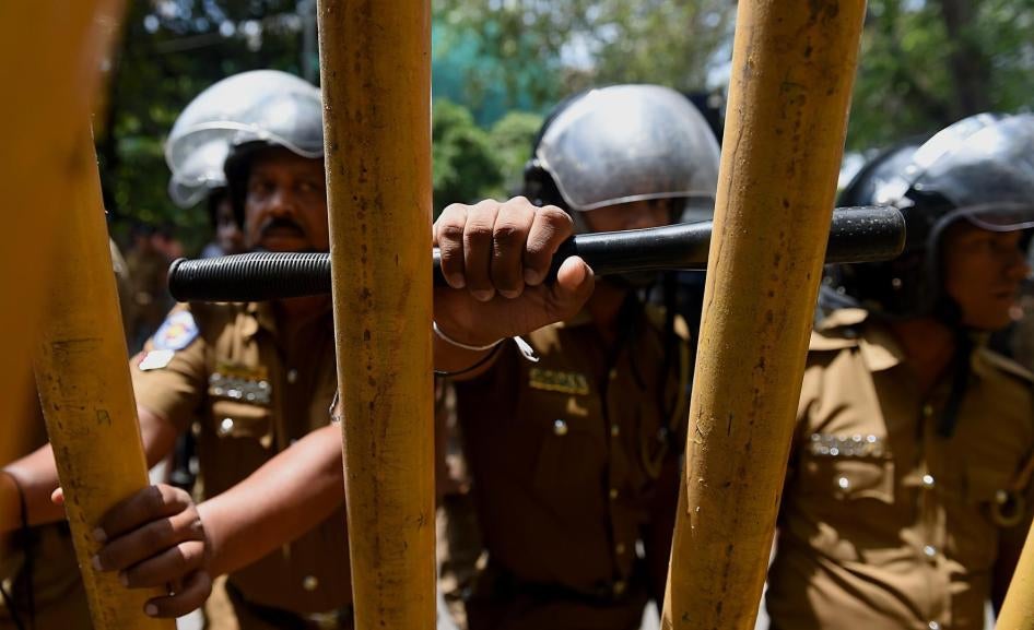 Sri Lankan police stand guard at a protest calling for the release of Tamil activists being held under the Prevention of Terrorism Act in Colombo, Sri Lanka, October 14, 2015.