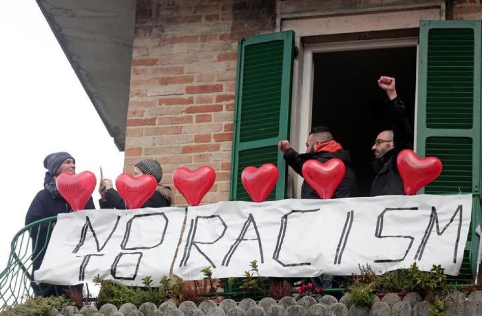 Demonstrators stand on a balcony during an anti-racism rally in Macerata, Italy, February 10, 2018. REUTERS/Yara Nardi