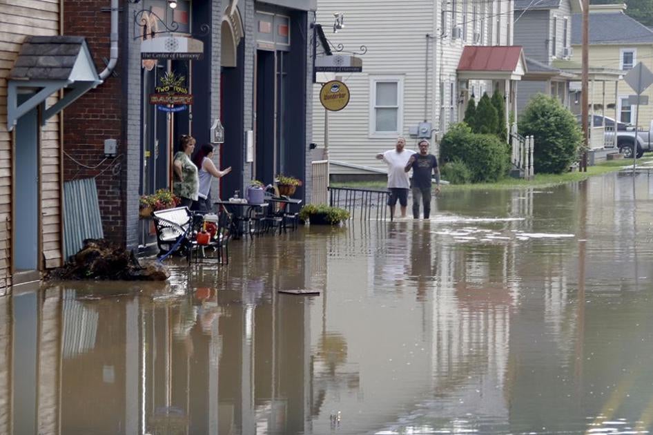 Business owners and workers assess flood waters in Harmony, Pennsylvania. 