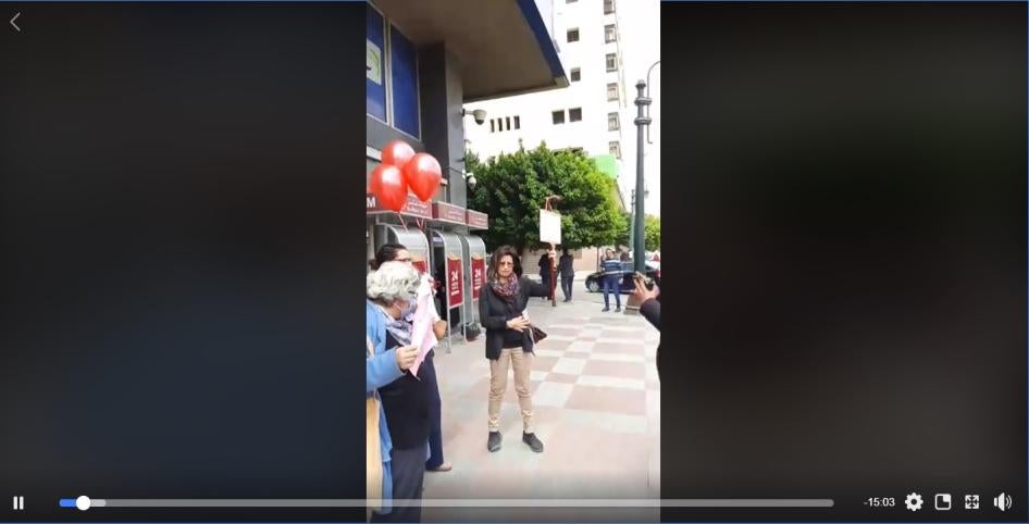 Screenshot of a live stream video from the protest showing Ahdaf Soueif, right, Laila Soueif, left, and Rabab al-Mahdy in between before they were arrested at the protest in downtown Cairo on March 18.