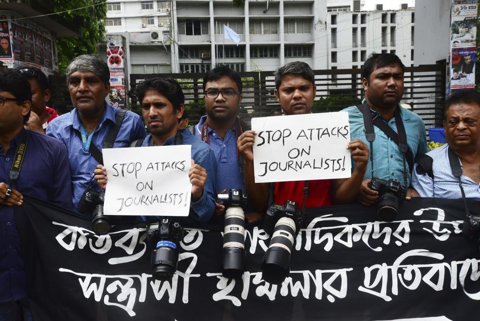 Bangladeshi photojournalists and journalists form a human chain infront of National Press Club protesting the attacks on them during the students' ongoing protest demanding safe roads, in Dhaka, Bangladesh on August 7, 2018.