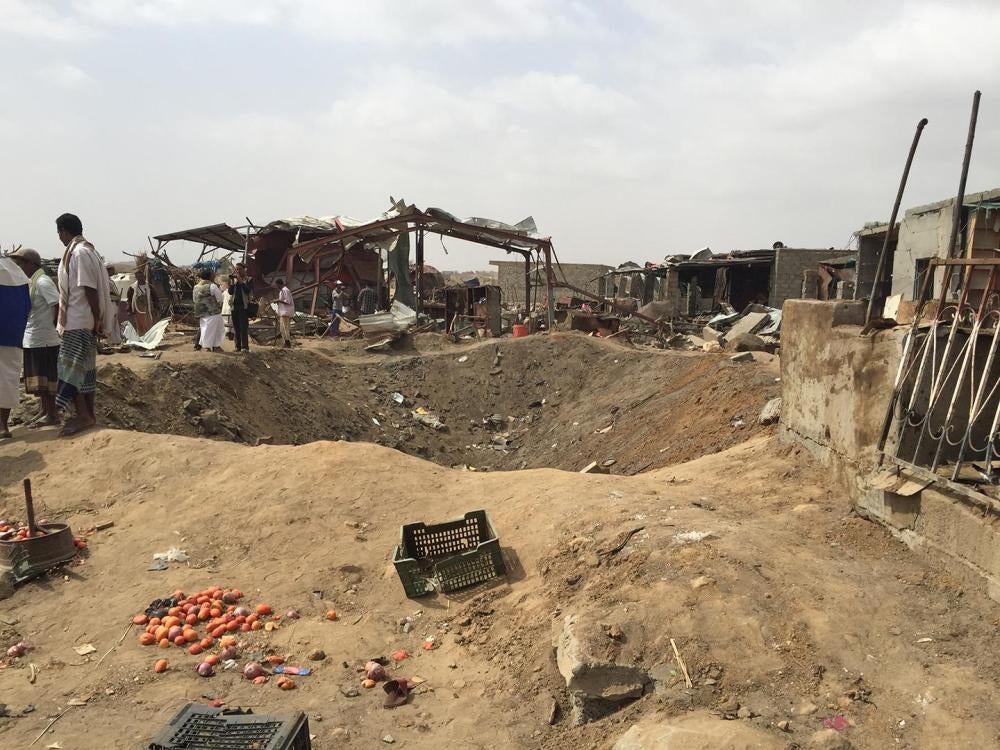The impact crater created by the first coalition airstrike in the Mastaba market on March 15, just in front of a row of shops and a restaurant. 