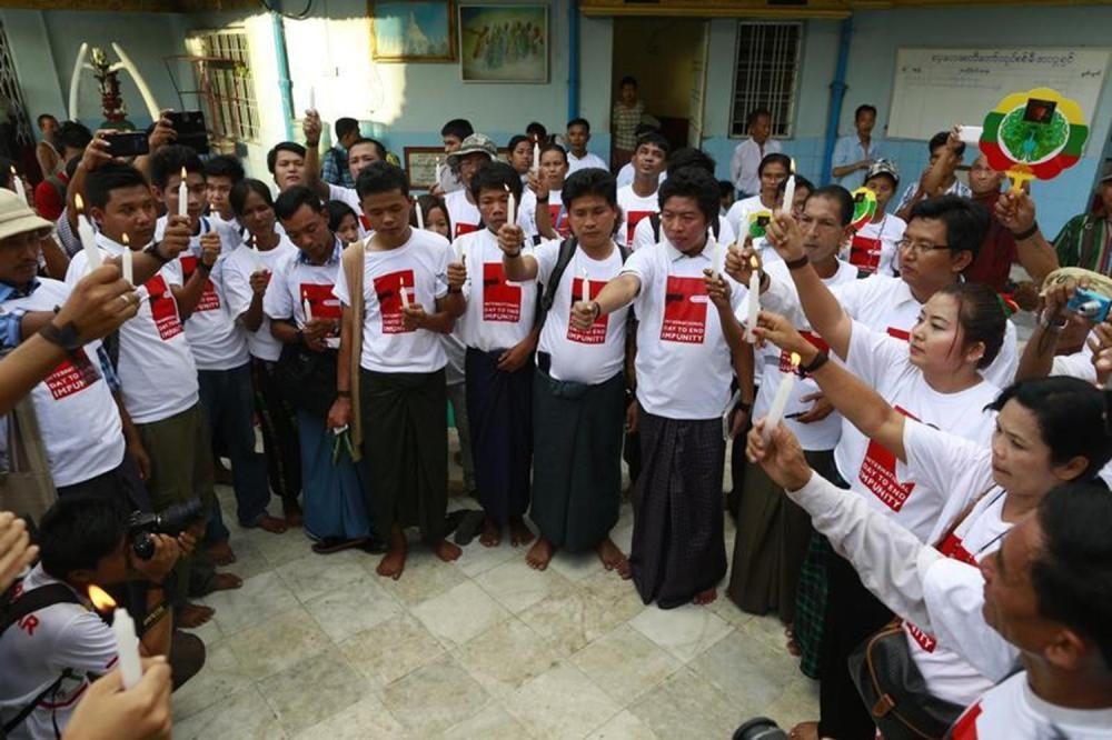 Journalists pray for colleagues who were killed or imprisoned for their work to mark the International Day to End Impunity for Crimes Against Journalists in Rangoon on November 2, 2014. 