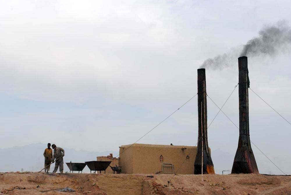 Brick makers feed coal into the kilns at a brick factory outside of Kabul. Children often start as young as 5 and work 12-hour days. 