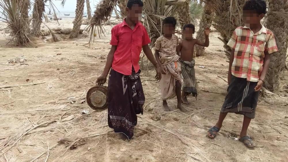 Children watch as mines are cleared on the western coast. The mine shown here has the fuze still in. © 2018 Private