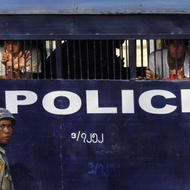Student protesters look out from a prison vehicle as they are transported to a court in Letpadan on March 11, 2015.