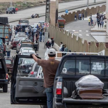 People transporting the remains of deceased loved ones wait in a slow moving line outside Jardines de la Esperanza Cemetery to hold burials in Guayaquil, Ecuador, April 6, 2020.