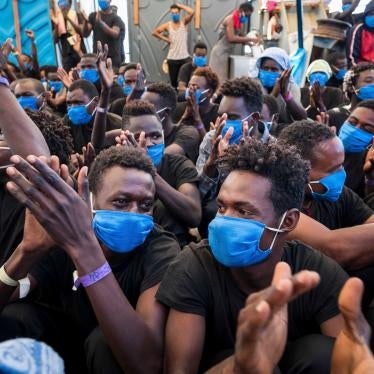 Men aboard the Sea-Watch 4, a nongovernmental rescue ship, rejoice on September 1, 2020, as they learn that they have permission to disembark in Palermo, Sicily, the next day.