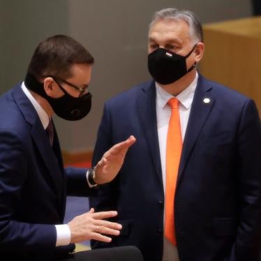 Poland's Prime Minister Mateusz Morawiecki, left, speaks with Hungary's Prime Minister Viktor Orban during a round table meeting at an EU summit at the European Council building in Brussels, December 10, 2020. 