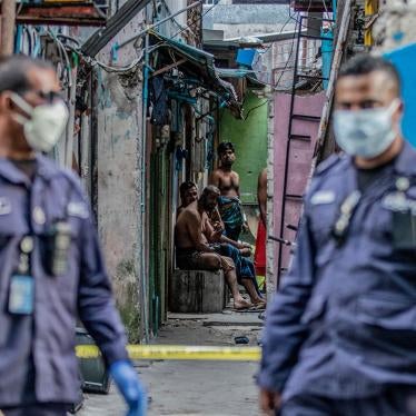 Security personnel patrol an accommodation block where Bangladeshi migrant workers are being quarantined after Covid-19 cases were found in the area, Malé, Maldives, May 9, 2020.