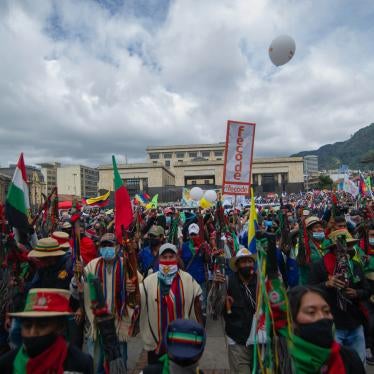 People march holding banners and flags