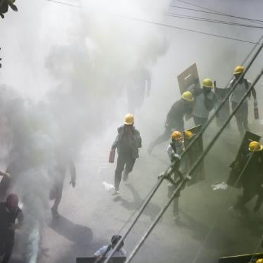 Protesters run in the middle of tear gas smoke during a demonstration against the military coup, Yangon, Myanmar, March 3, 2021.