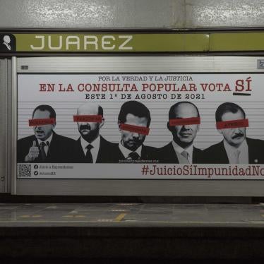 Commuters walk past an advertisement showing images of several former Mexican presidents, calling for citizens to participate in a referendum on whether ex-presidents should be tried for their alleged crimes during their time in office, in Mexico City, Saturday, July 31, 2021.