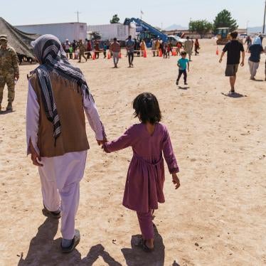 A man walks with a child through Doña Ana Village in Fort Bliss, where Afghan refugees are being housed, in New Mexico on September 10, 2021.