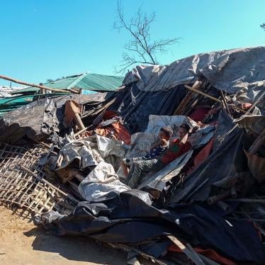 Rohingya refugees lie on a razed shop demolished by authorities in the Kutupalong camp in Ukhia, Bangladesh, December 10, 2021. 