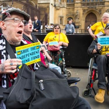 Protesters in wheelchairs hold signs