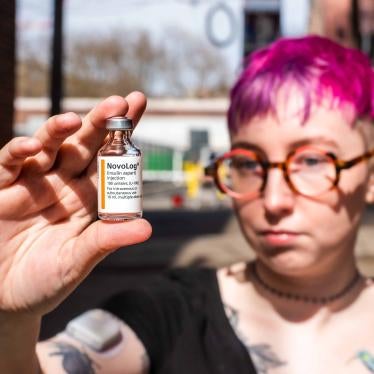 A person holding a vial of insulin