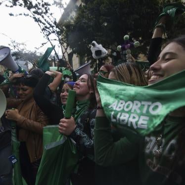 Activists holding green bandanas 