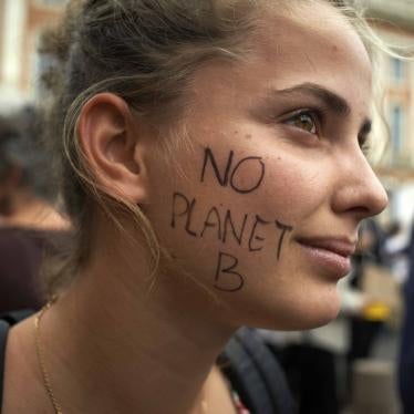 A protester with "NO PLANET B" written on her face attends a climate change demonstration in Toulouse, France, September 23, 2022.