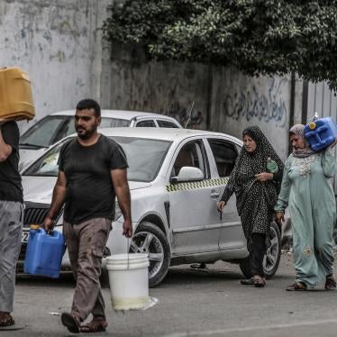 Palestinians carry their bottles of water after Israeli authorities have ceased supplying electricity, water and food in the Gaza Strip, October 17, 2023.