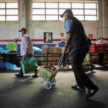 Volunteers attend to people at the Food Bank of Lugo, May 2, 2023, in Lugo, Galicia, Spain.