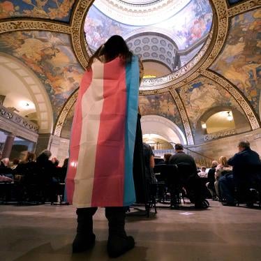 Glenda Starke wears a transgender flag as a counter protest during a rally in favor of a ban on gender-affirming health care legislation, March 20, 2023, at the Missouri Statehouse in Jefferson City. ©2023 AP Photo/Charlie Riedel, File