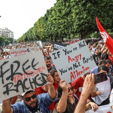 Demonstrators wave Tunisian flags and raise placards during a demonstration organized by the Tunisian Network for Rights and Freedoms in Tunis, Tunisia, on September 22, 2024.