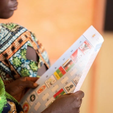 A woman looks at a ballot paper in Giheta Commune of Gitega Province in Burundi