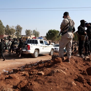 Syrian government security forces stand atop an earth barrier that they created as a buffer during their deployment in Busra al-Harir in Syria’s southern Daraa province on July 21, 2025.