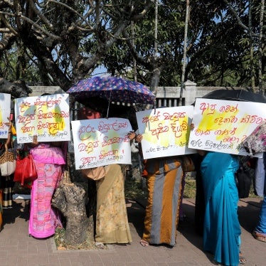 People hold placards at a protest