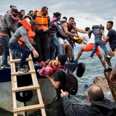 Asylum seekers and migrants descend from a large fishing vessel used to transport them from Turkey to the Greek island of Lesbos. October 11, 2015. 
