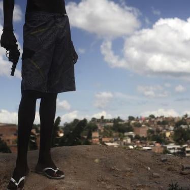A 17-year-old Brazilian drug gang member poses with a gun atop a hill overlooking a slum in Salvador, Bahia State on April 11, 2013.