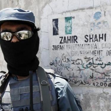 An Afghan policeman stands guard at the entrance of a local school sponsored by Japan’s International Cooperation Agency in Kandahar City May 11, 2010. © 2010 Nikola Solic / Reuters