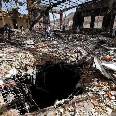 Journalists and police inspect the scene at the community hall in Sanaa that Saudi-led coalition warplanes attacked on October 8, 2016. 