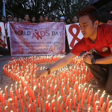 Filipinos light candles, which are shaped into an AIDS symbol, to mark World AIDS Day on December 1, 2012, in Manila, Philippines.